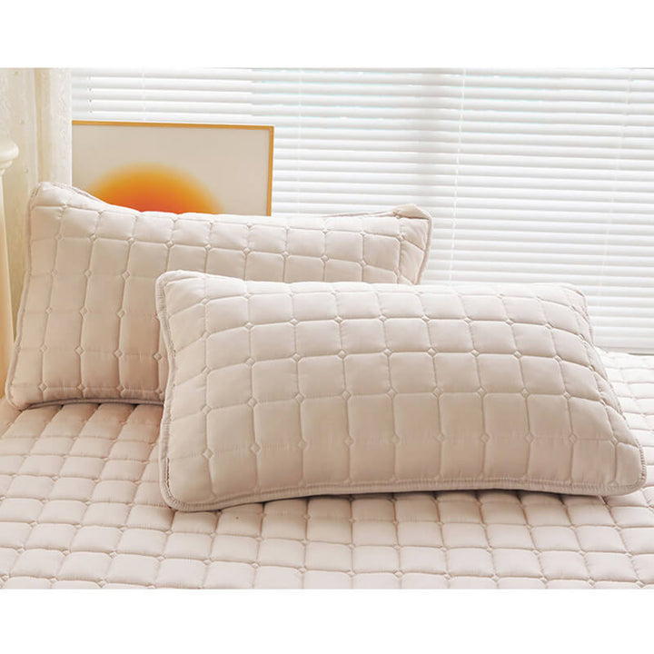 Hand touching the surface of waterproof mattress protector, feeling its soft, silent texture.