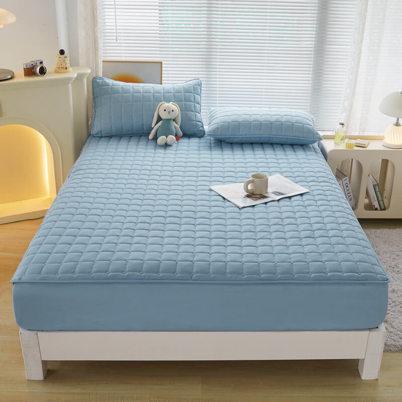Bundle of home textiles including a waterproof mattress protector, emphasizing complete bedding protection.
