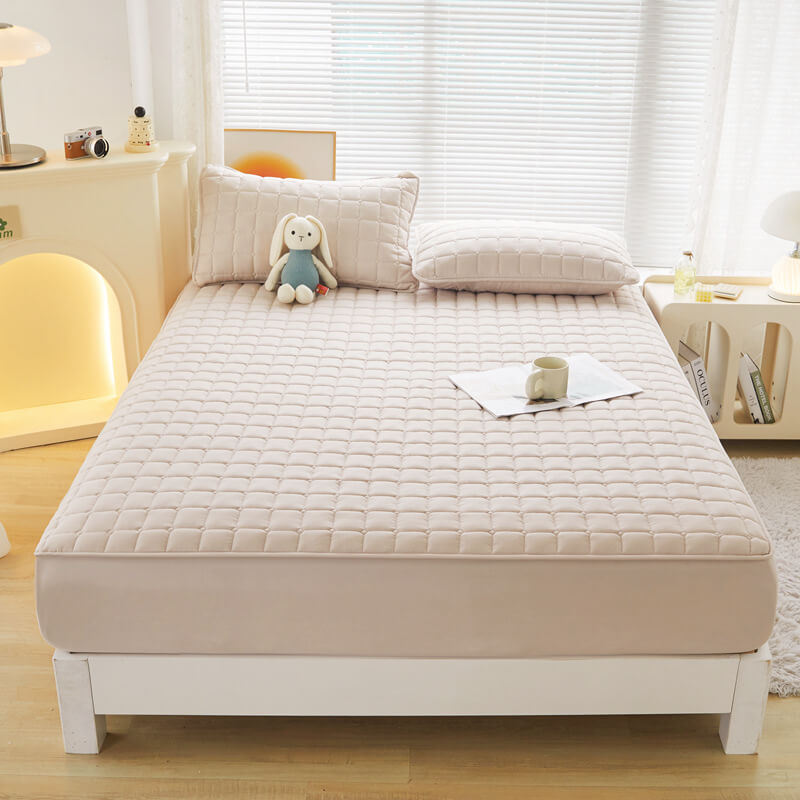 Elasticized skirt of a waterproof mattress protector, ensuring a snug fit for deep mattresses.