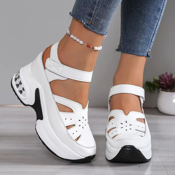 Elegant women's wedge walking sandals with a breathable cutout platform and adjustable strap for everyday wear.