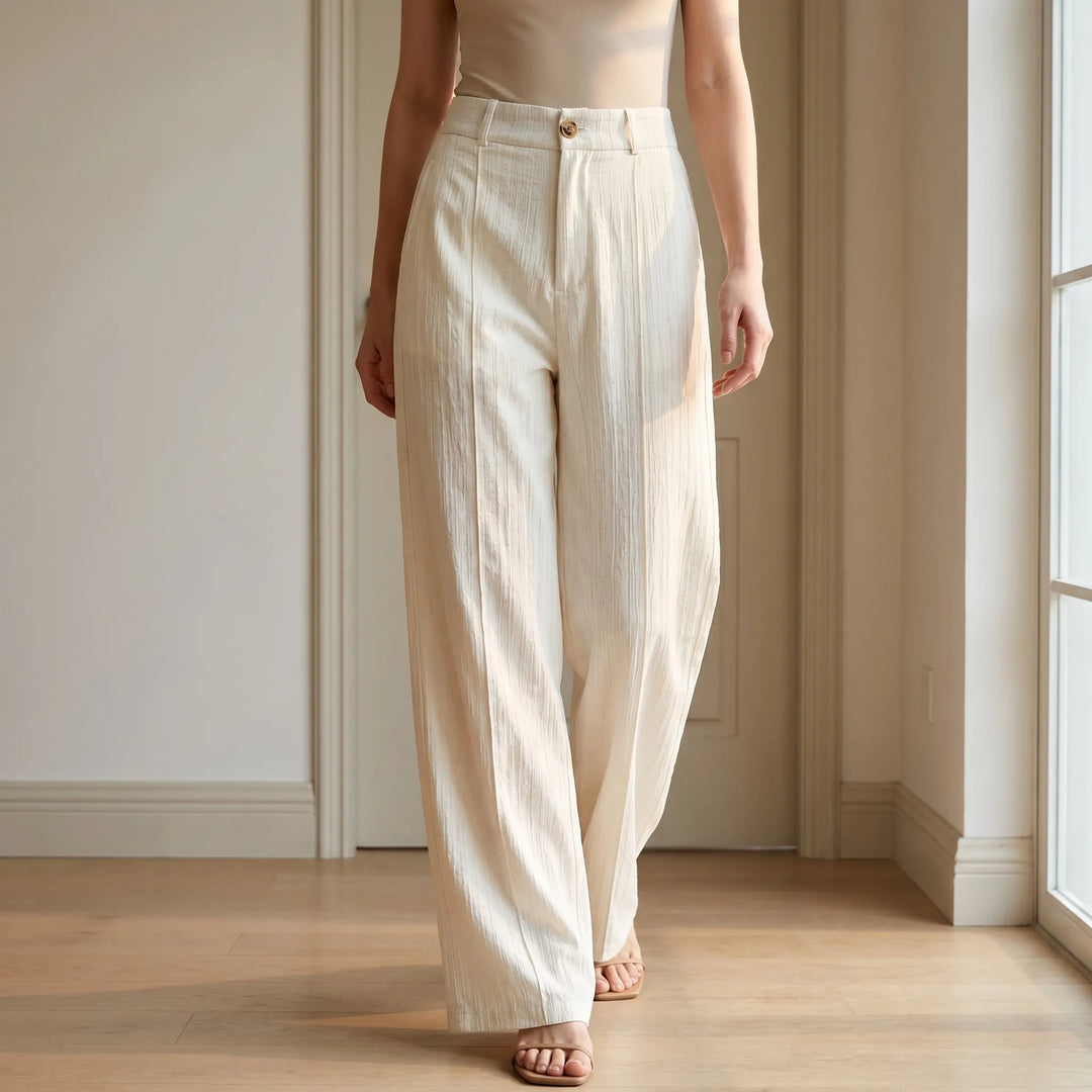 White women's breezy wide-leg summer pants, full length, relaxed fit. Perfect for elegant resort wear & casual style.