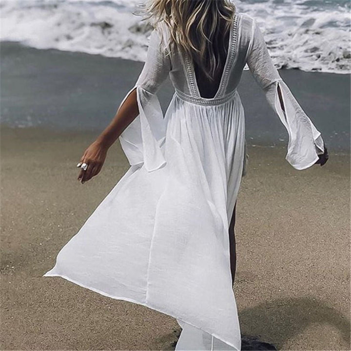 White women's maxi beach dress with open back & flowy flare sleeves, ideal for resort wear.