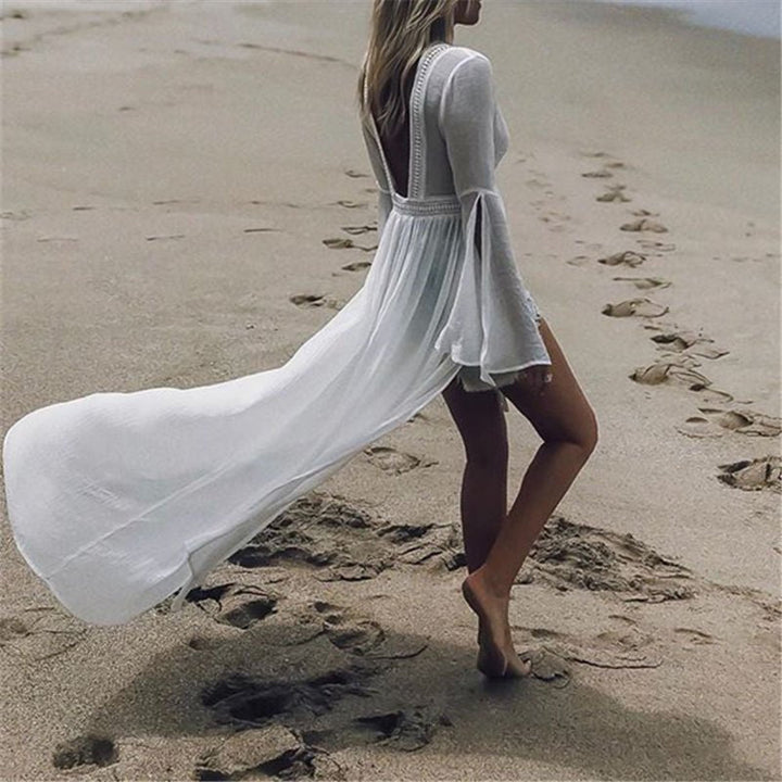 Flowy white maxi beach dress for women, featuring a stunning open back & graceful flare sleeves.