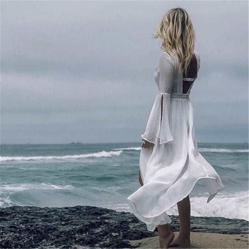 Women's white resort wear maxi dress featuring a beautiful open back & elegant flare sleeves.