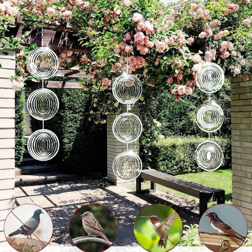 Orchard defense: Multiple reflective, wind-powered bird deterrents mounted, providing wildlife-friendly pest control