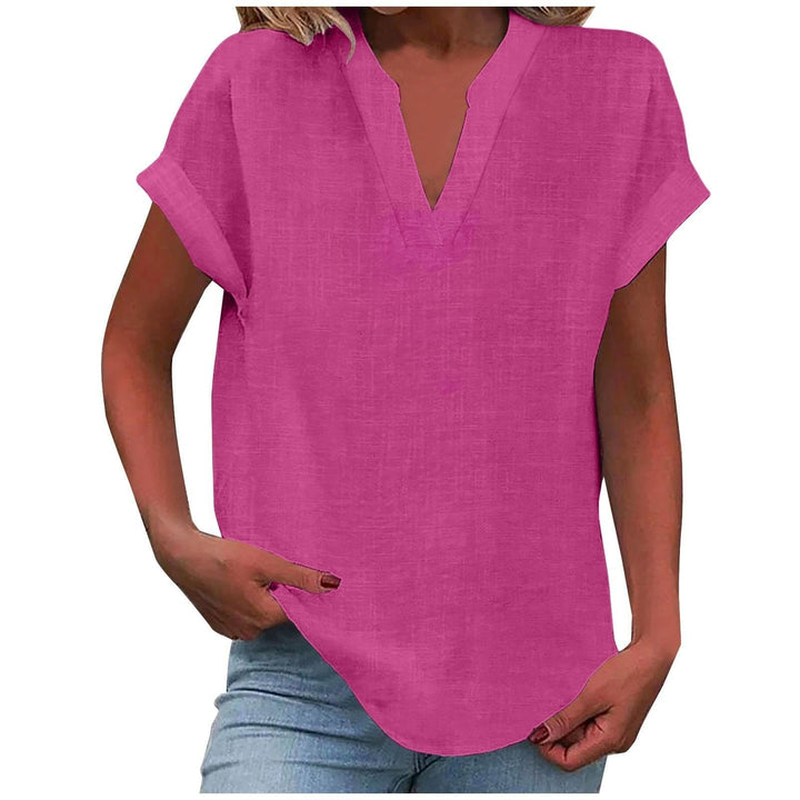 Woman posing in comfortable V-neck blouse, highlighting relaxed fit for summer days & casual elegance.
