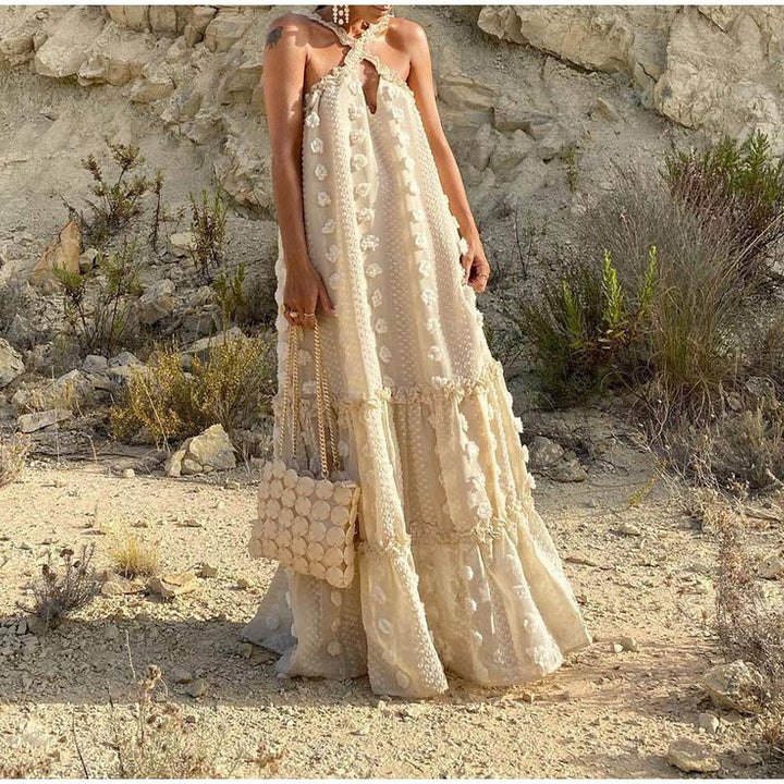 Woman enjoying a beach vacation in a comfortable, flowy maxi dress, showcasing its effortless summer style.