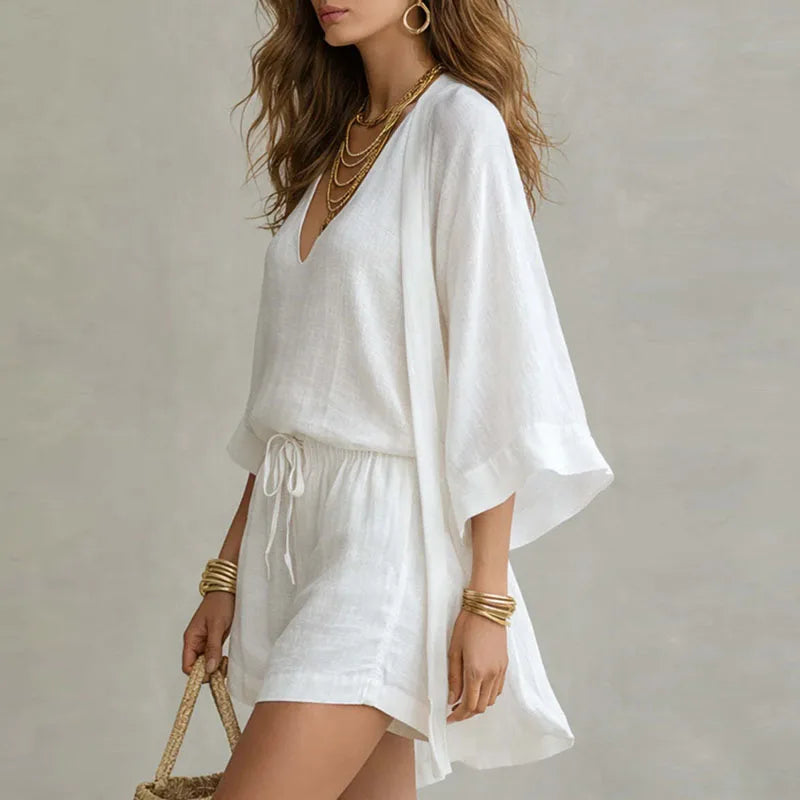 Effortless women's summer outfit: cozy elegant cami, shorts, and flowing kimono. Casual chic vacation style.