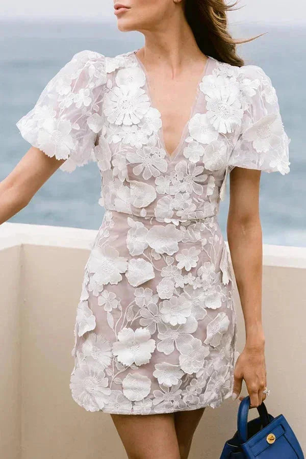 Flattering V-neck mini dress for women with unique 3D floral details and fashionable puff sleeves.