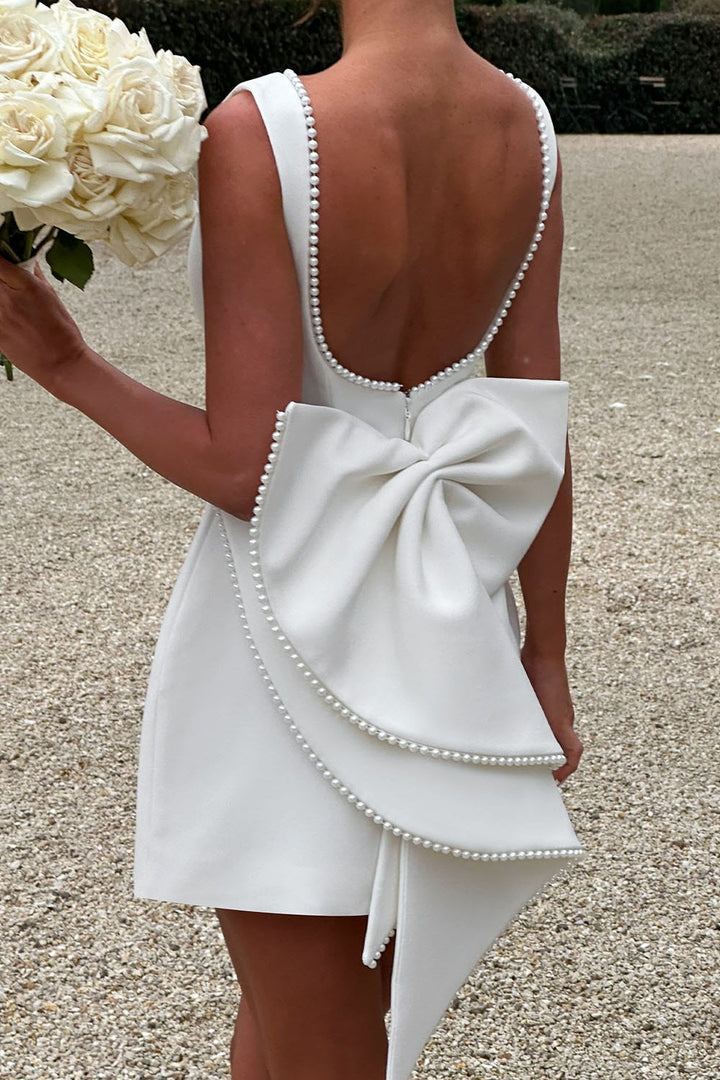 Elegant women's cocktail dress: A-line mini, pearl trim, and a chic back bow, perfect for special occasions.