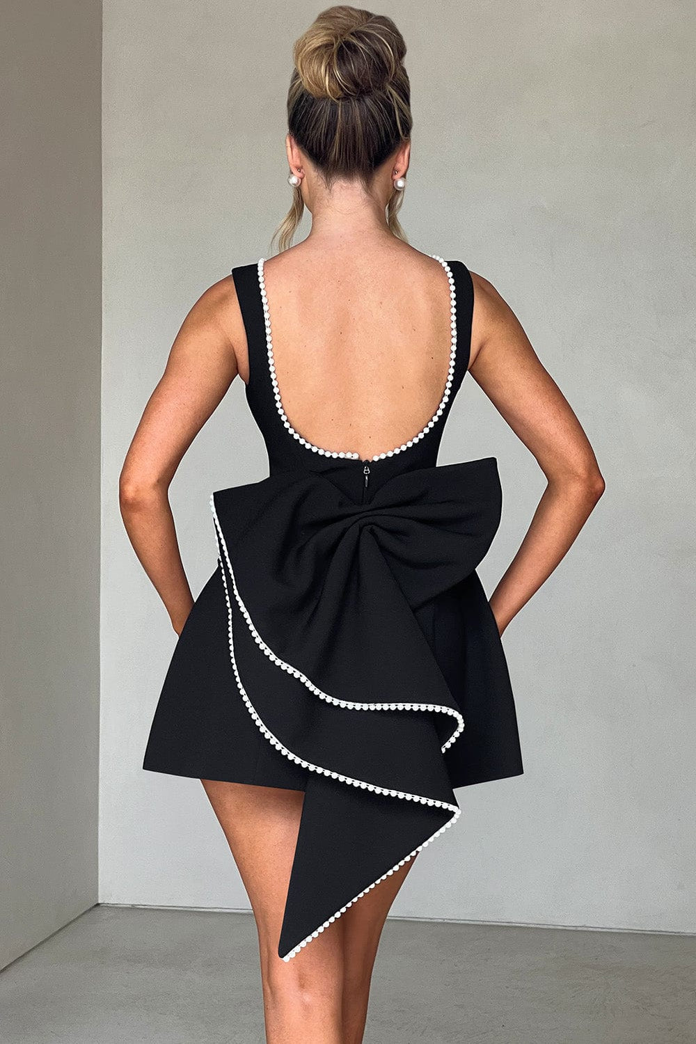 Gorgeous women's party dress: pearl embellished A-line mini with a captivating back bow, chic & elegant.