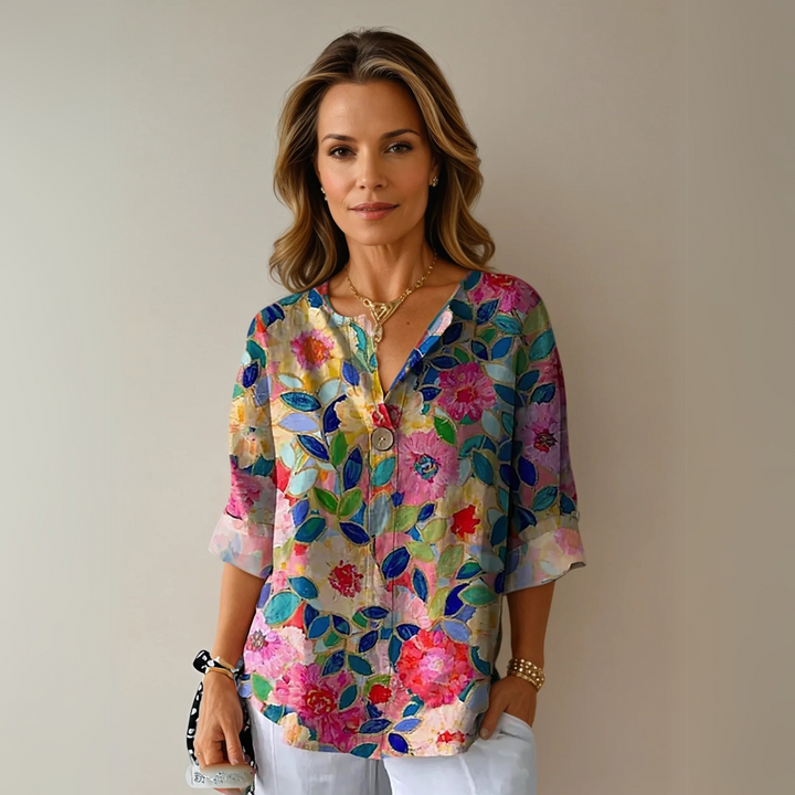 Women's abstract floral V-neck blouse, relaxed fit summer top. Elegant casual fashion with 3/4 sleeves.