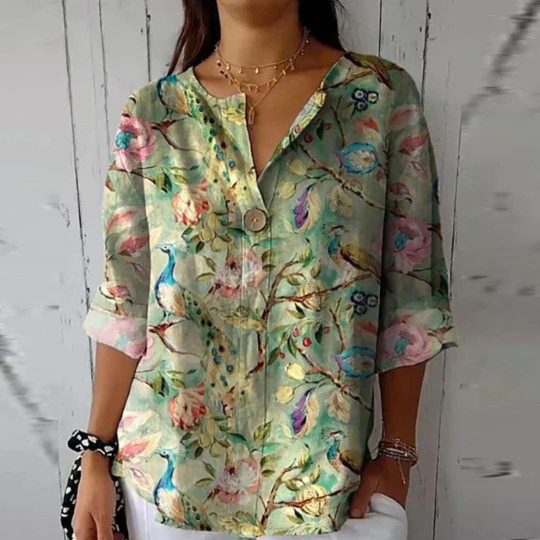 Versatile women's button-up V-neck blouse, abstract floral design. Relaxed summer top for elegant casual occasions.