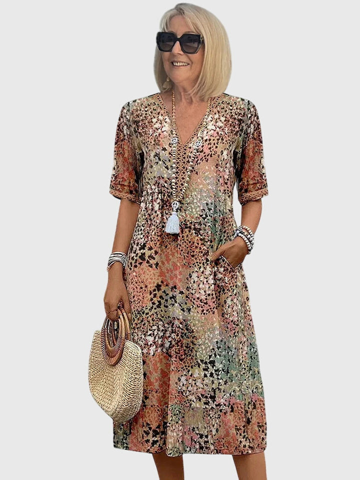 Women's abstract print boho midi summer dress with V-neck and flutter sleeves, perfect for casual day or vacation.