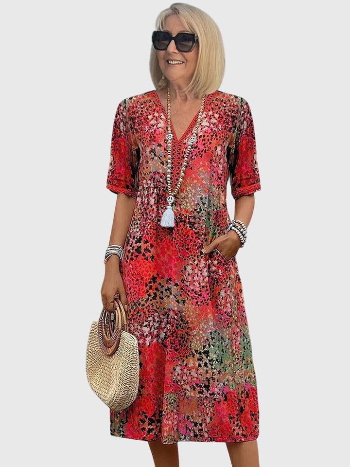 Boho V-neck midi dress for women featuring a vibrant abstract floral print and comfortable flutter sleeves.