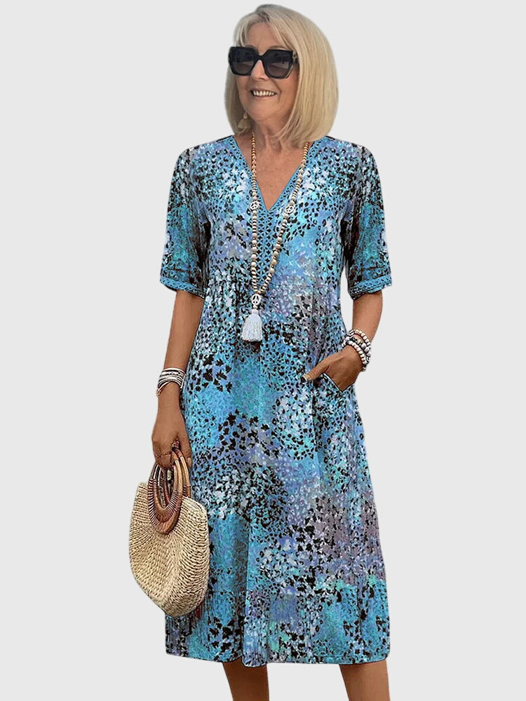 Elegant women's V-neck summer midi dress with flutter sleeves and a unique abstract print for sunny days.