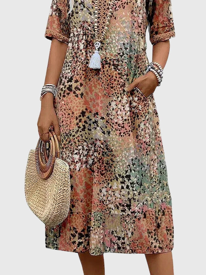Stylish women's summer vacation dress, V-neck abstract print boho midi with flutter sleeves for a chic look.