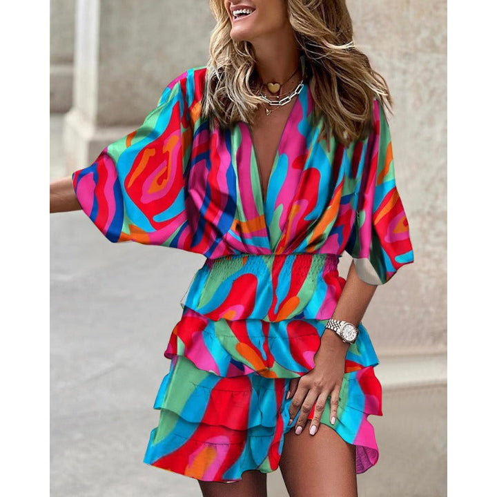 Colorful women's abstract mini dress, smocked waist, tiered ruffles & batwing sleeves. Ideal for festivals.