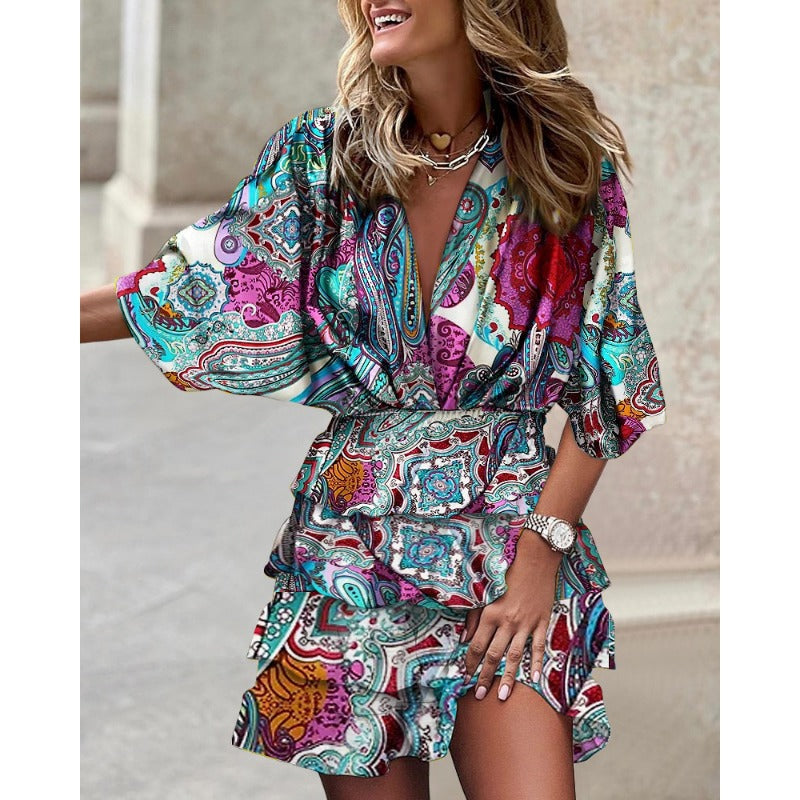 Flowy women's abstract print smocked mini dress with tiered ruffles, V-neck, and batwing sleeves for summer.
