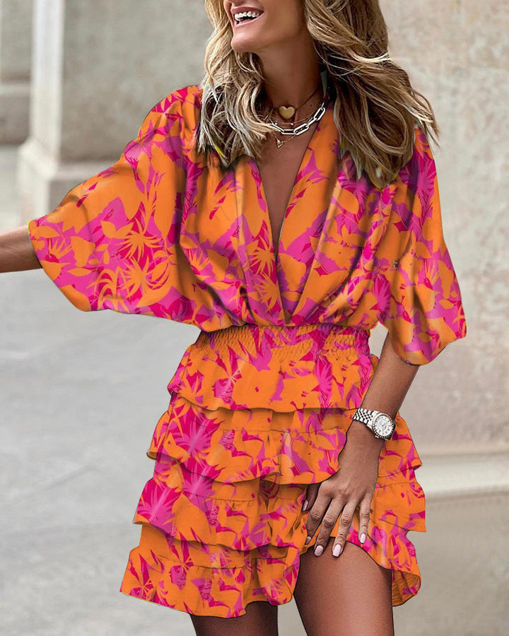 Women's party-ready abstract print smocked tiered ruffle mini dress, a colorful and trendy summer choice.