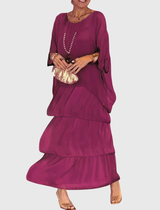 Full-length women's abstract print tiered maxi dress, bohemian flowy silhouette for summer.