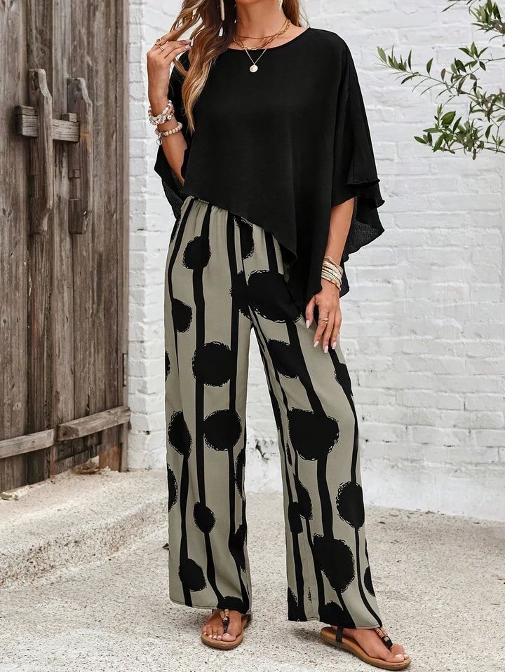 Modern women's abstract print matching set: stylish batwing top & comfortable wide leg trousers.