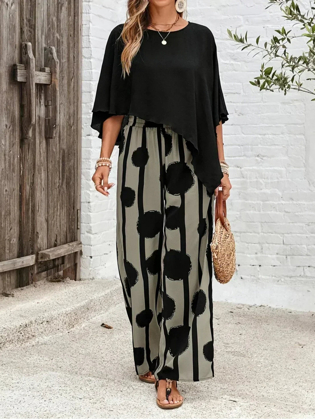Trendy women's abstract print wide leg trouser and batwing top set, versatile casual outfit.