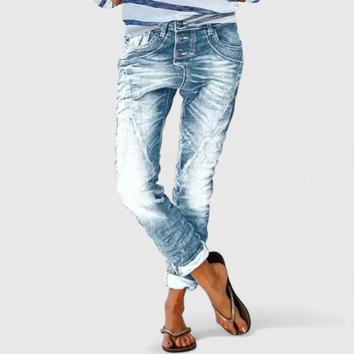 Vintage-style acid wash women's skinny denim jeans, showcasing bold contrast stitch accents and slim fit.
