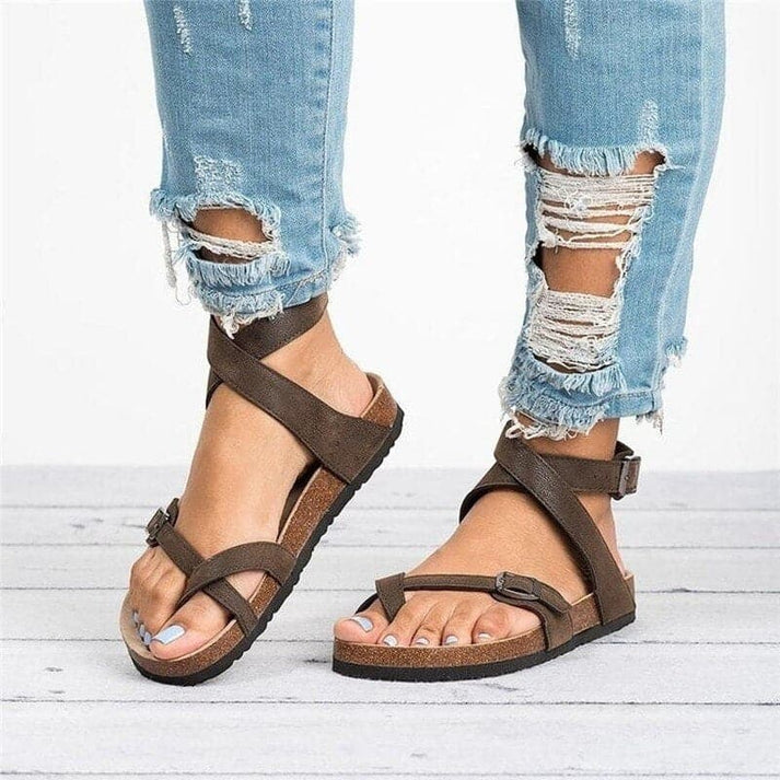 Women's adjustable strappy flat sandals in a neutral tone, designed for all-day comfort and casual summer wear.