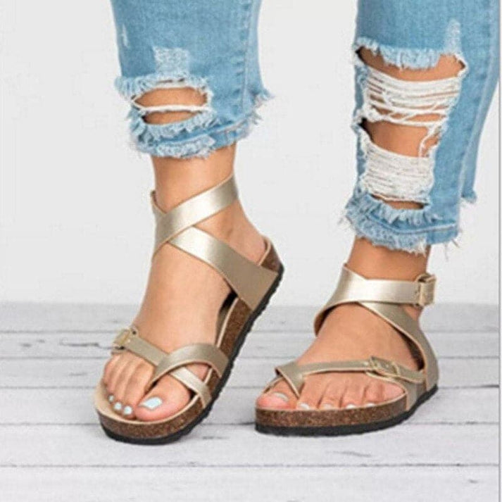 Comfortable women's adjustable flat sandals with criss-cross straps, ideal for everyday summer walking.