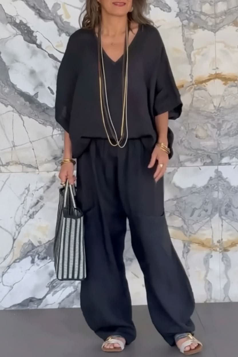 Stylish women's airy pantsuit with an open back detail. Comfortable, relaxed fit two-piece set for summer and travel.