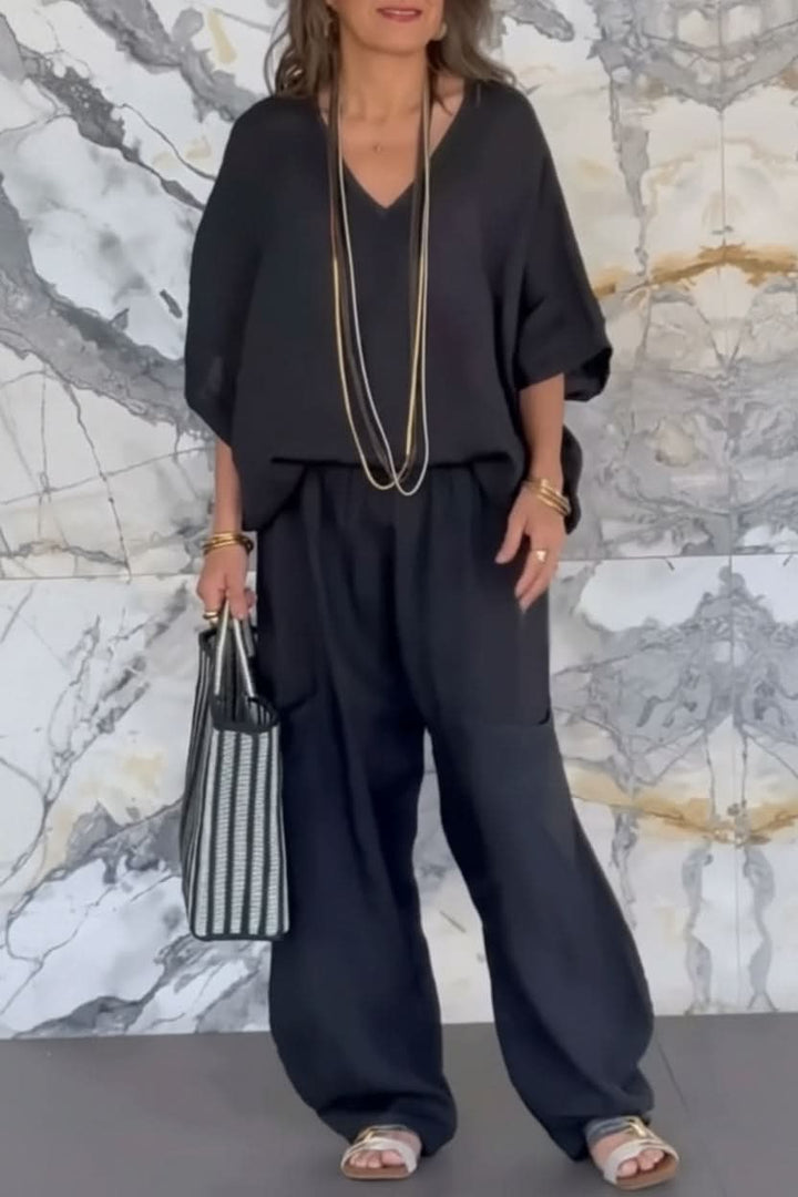 Stylish women's airy pantsuit with an open back detail. Comfortable, relaxed fit two-piece set for summer and travel.