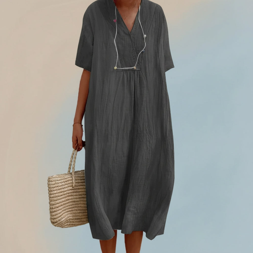 Stylish women's Aria midi dress for summer vacation. Comfortable A-line V-neck flowy fashion with pockets.