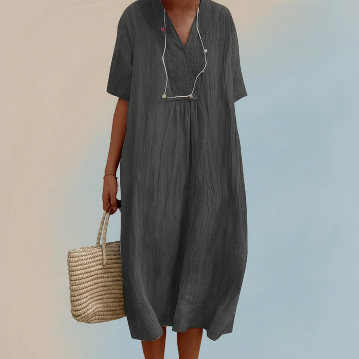 Stylish women's Aria midi dress for summer vacation. Comfortable A-line V-neck flowy fashion with pockets.