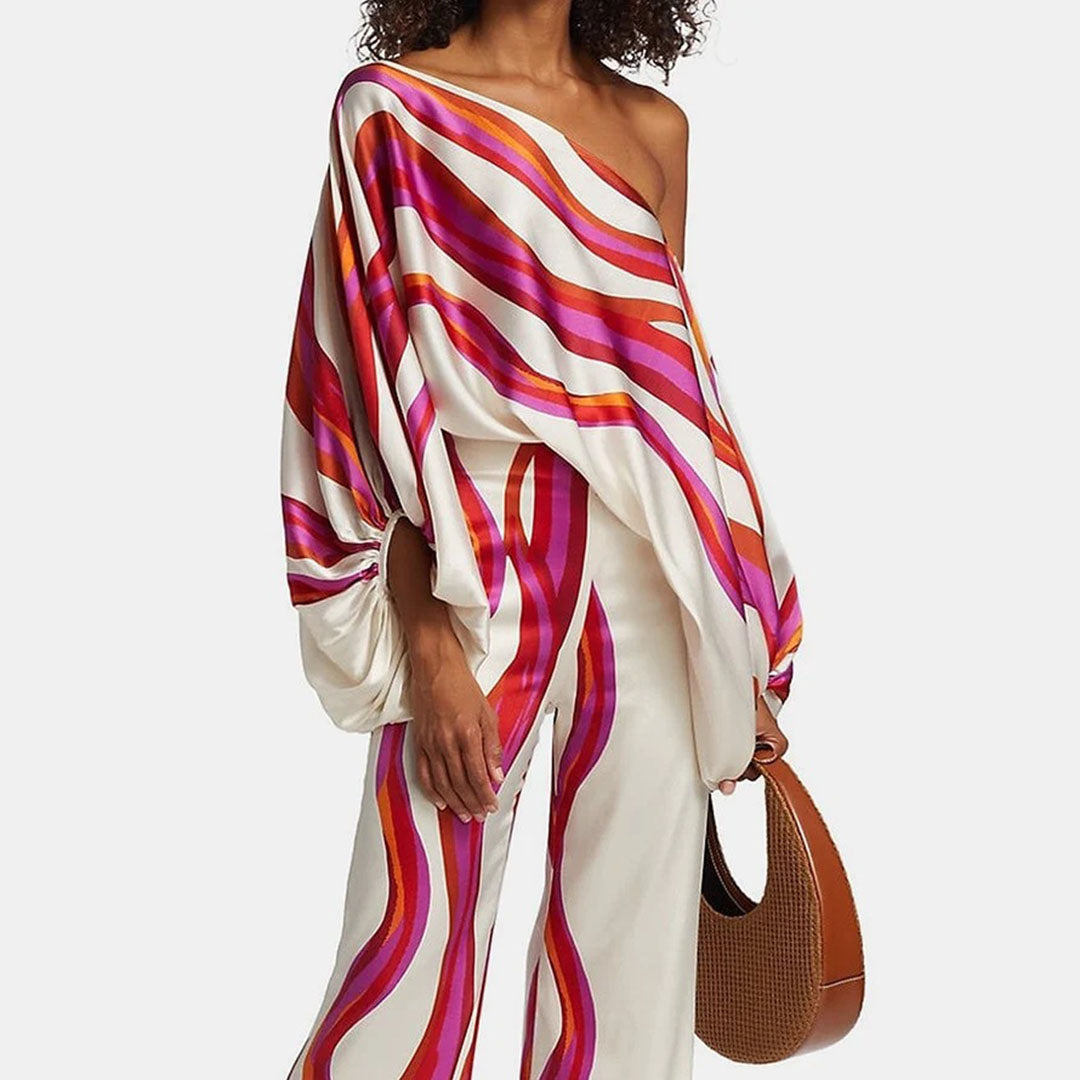 Women's artistic abstract print one-shoulder top & wide-leg pants set. Chic resort wear for elegant casual style.