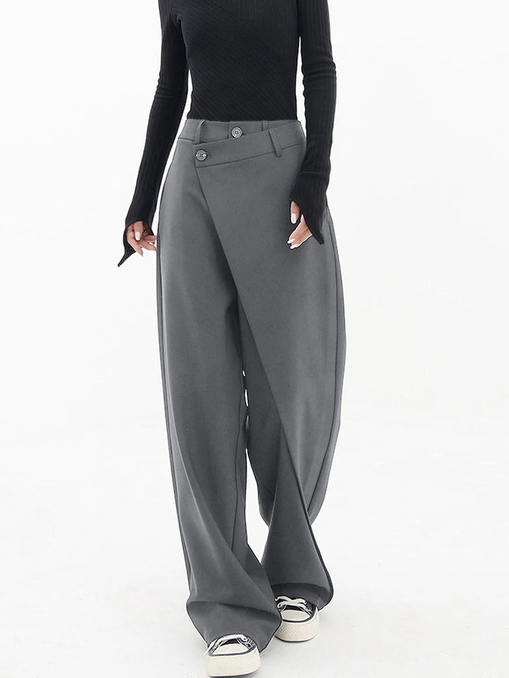 Close-up of the asymmetric detail on women's relaxed fit baggy trousers, showcasing unique modern style.