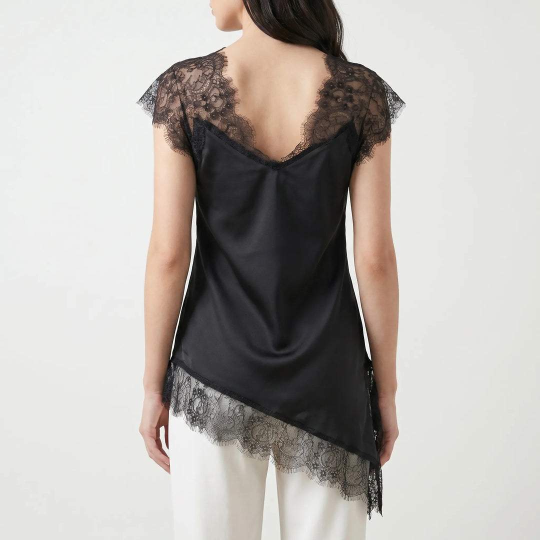 Elegant white asymmetrical top with sheer details and sleeveless design. Perfect for a chic summer look.