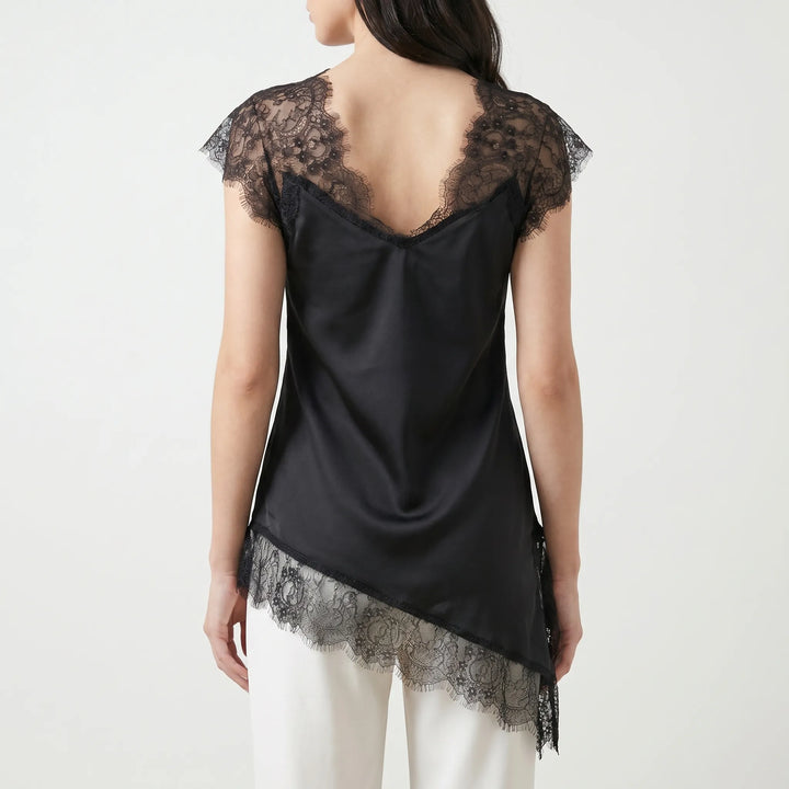 Elegant white asymmetrical top with sheer details and sleeveless design. Perfect for a chic summer look.