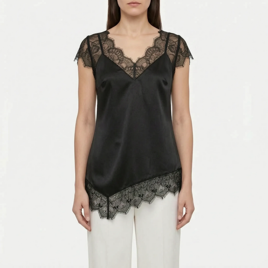 Stylish women's asymmetrical blouse in white, featuring sheer panels, sleeveless design, and an elegant v-back.