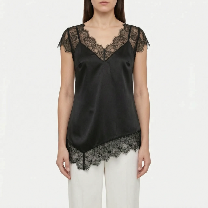 Stylish women's asymmetrical blouse in white, featuring sheer panels, sleeveless design, and an elegant v-back.