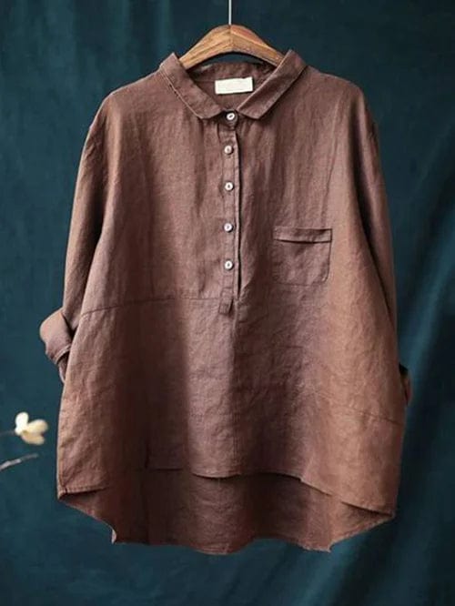 White women's button up blouse with an asymmetrical hem, ideal for resort wear.