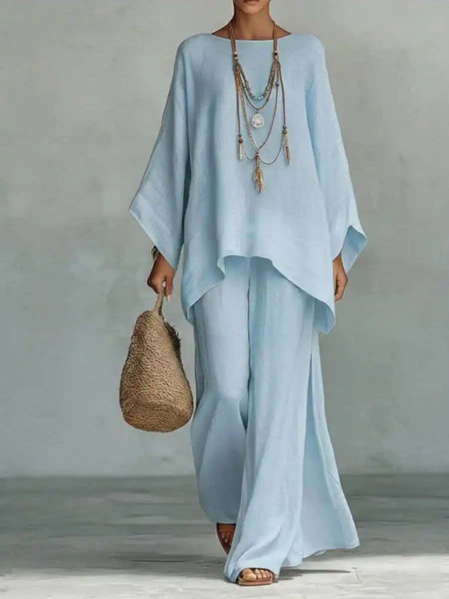 Elegant women's asymmetrical 2-piece set. Features a unique top & flowy wide-leg pants, perfect for warm weather style.