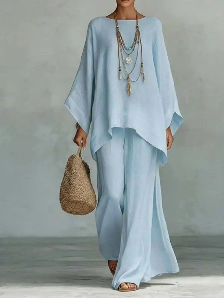 Elegant women's asymmetrical 2-piece set. Features a unique top & flowy wide-leg pants, perfect for warm weather style.