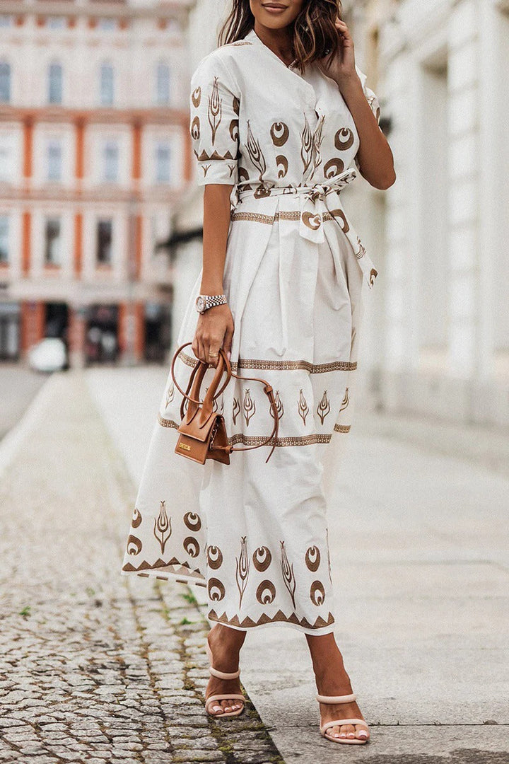Vibrant Aztec pattern on a women's midi dress. Features button-down front, a cinching belt & a flattering flared skirt.