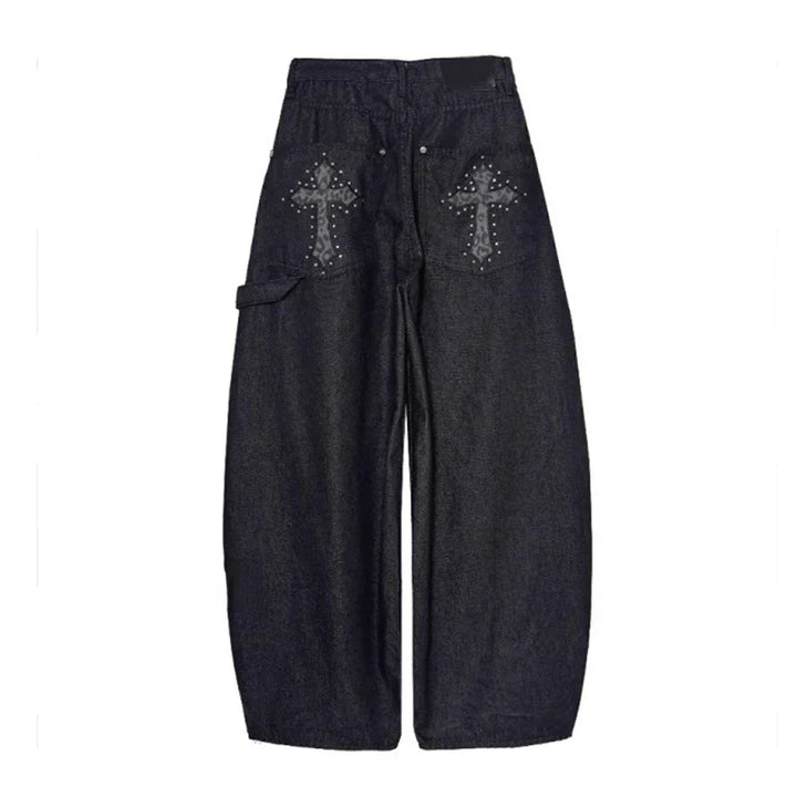 Fashionable women's baggy wide-leg pants, low-rise with a bold studded cross, embracing alternative & streetwear.
