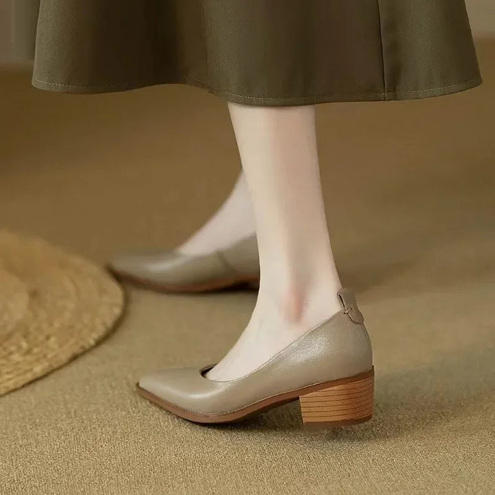 Stable block heel detail on women's pointed toe slip-on court shoes, comfortable for all-day elegant wear.