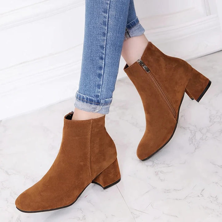 Women's black ankle boots with comfortable block heel and practical side zip, perfect for versatile casual everyday wear.