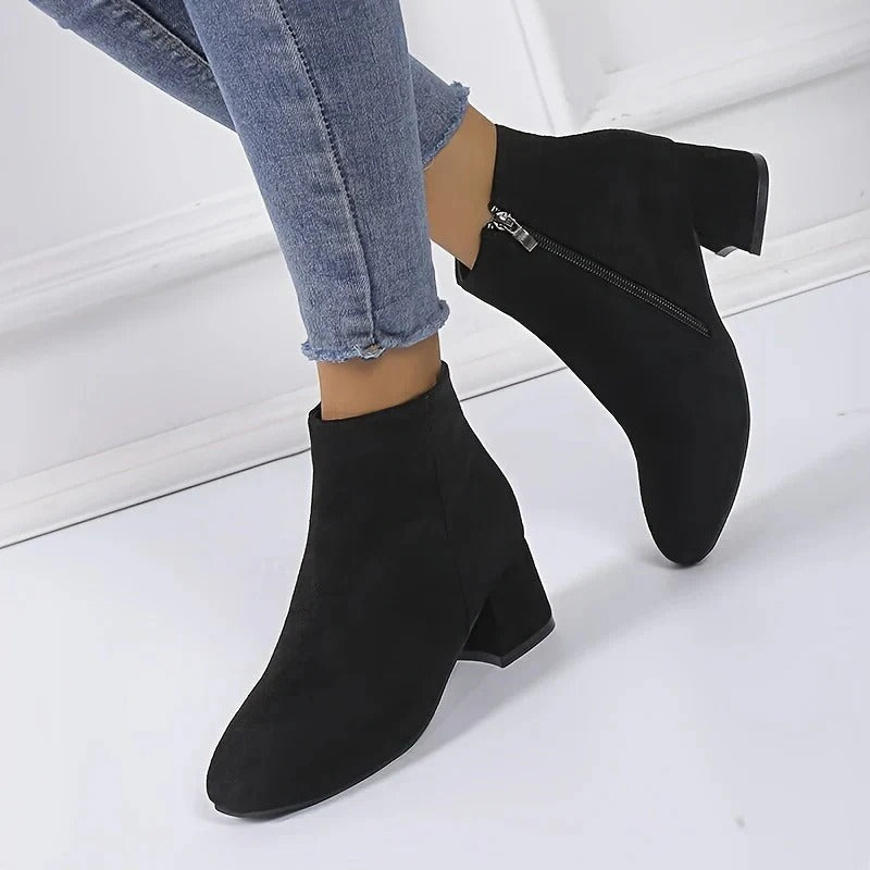 Elegant black women's ankle boots featuring a sturdy block heel and functional side zip for easy wear.