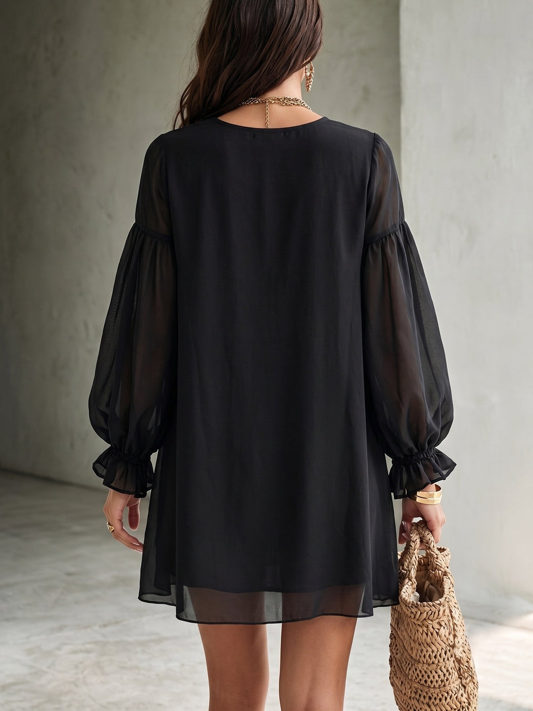 Chic black bohemian mini dress for women, featuring a flattering V neck and stylish ruffle balloon sleeves.