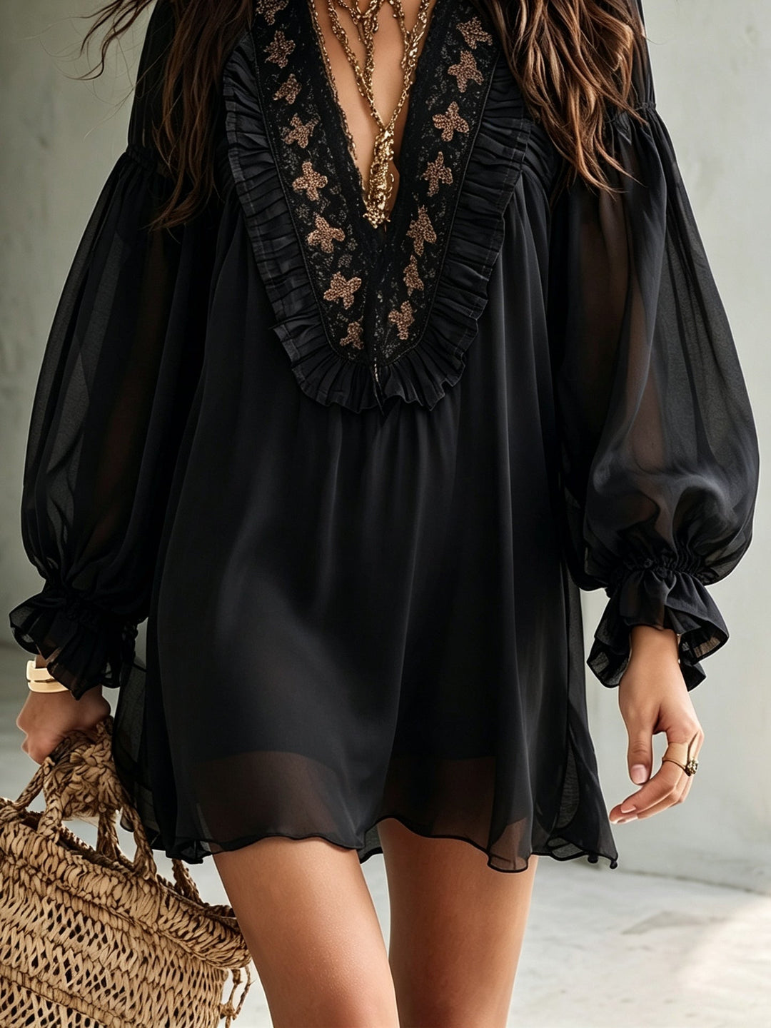 Flowy black boho mini dress for women, designed with a V-neck, voluminous balloon sleeves, and a chic ruffle hem.